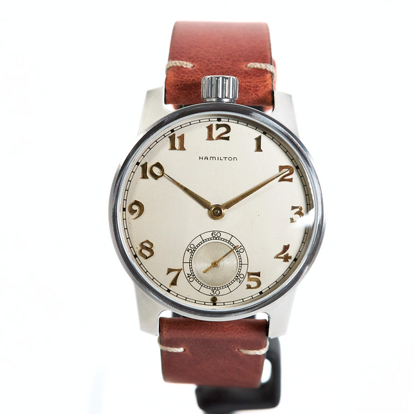 Watch with a brown leather strap on a white background