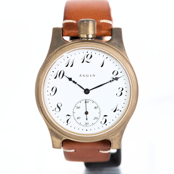 Wristwatch with brown leather strap and white face on a white background