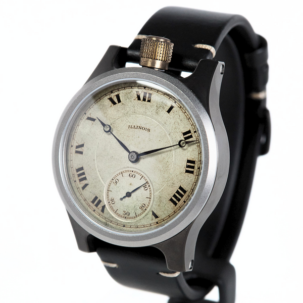 A vintage-style wristwatch with a black strap, silver-toned case, and a distressed cream-colored dial featuring black Roman numerals and hands.