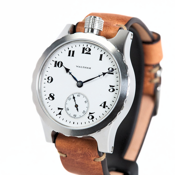 A Waltham wristwatch featuring a silver-toned metal case, a white dial with black Arabic numerals, and a brown leather strap, shown against a plain white background.