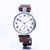 Wristwatch with a brown leather strap on a white background