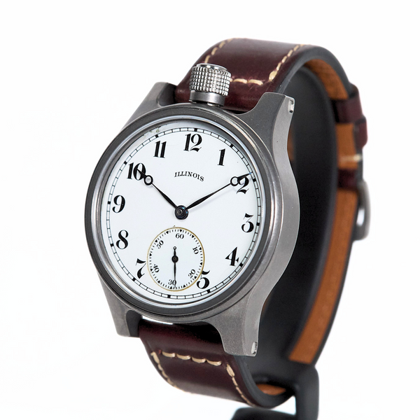A vintage-style wristwatch with a silver-toned metal case, white dial with black Arabic numerals, and a brown leather strap with white stitching, shown on a white background.