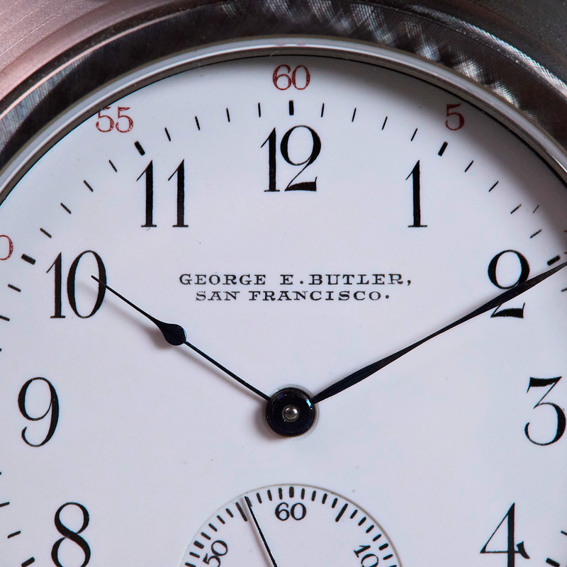 Close-up of a watch face with 'George E. Butler, San Francisco' branding.