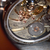 Close-up of a watch mechanism with visible branding on a textured surface