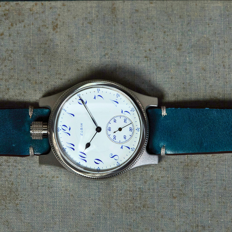 Wristwatch with blue strap on a textured surface